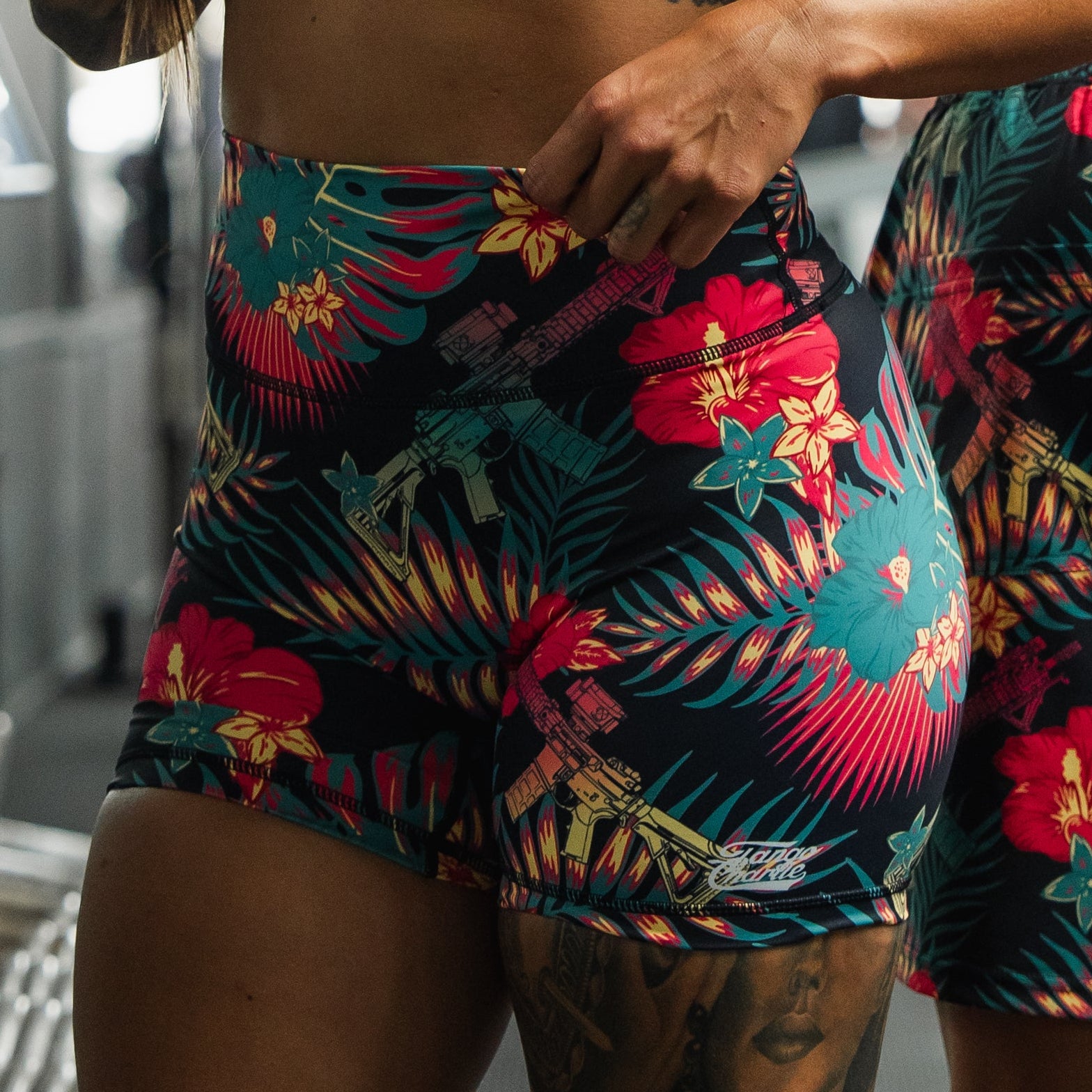Colorful tropical patterned shorts worn by a person.